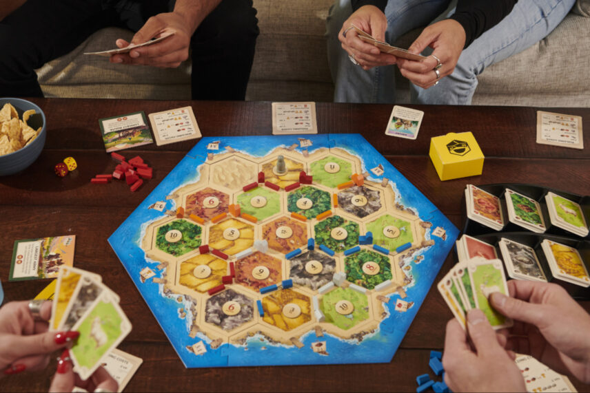 Four people playing Catan