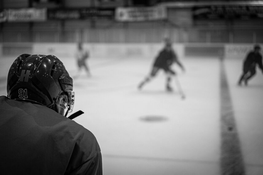 Black and white scale image of hockey player looking at the ice