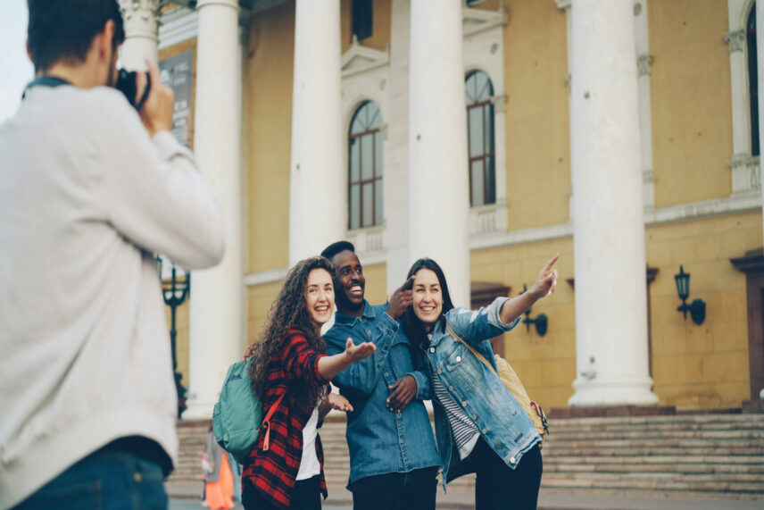 Bad tourists strike inappropriate poses for selfies at monuments they lack all cultural understanding of.