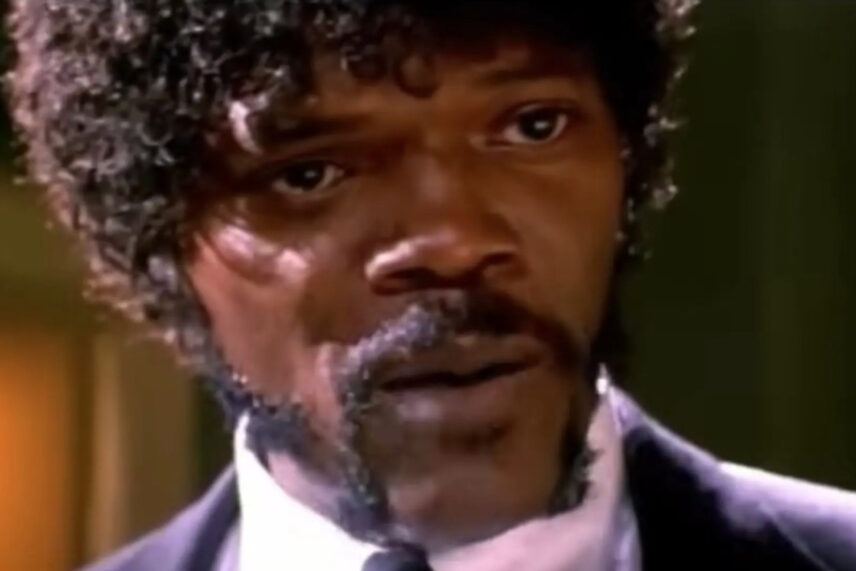 man in suit with afro hairstyle and mustache