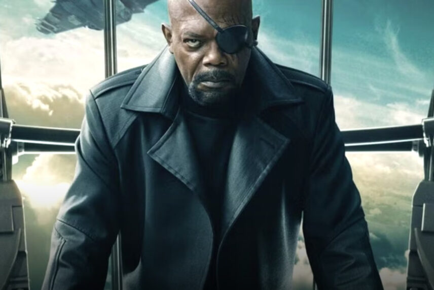 man with black trench coat and eye patch frowning
