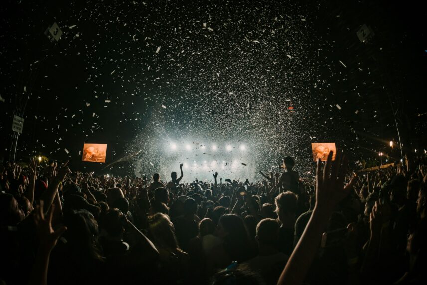 A cheering crowd with confetti in the air