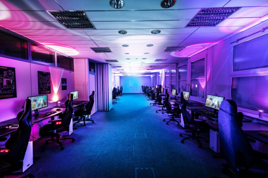 Numerous PCs and gaming chairs lined up
