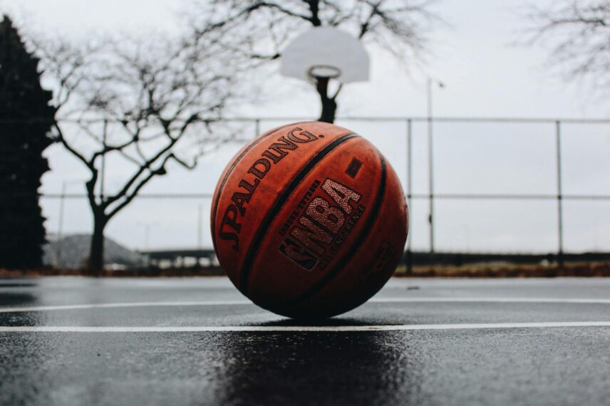 Basketball on wet ground at a park