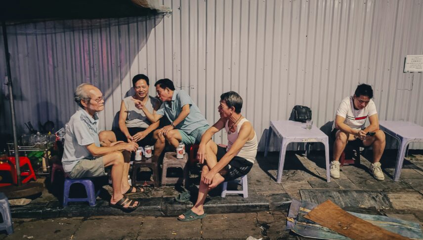 People Sitting Around Outdoors