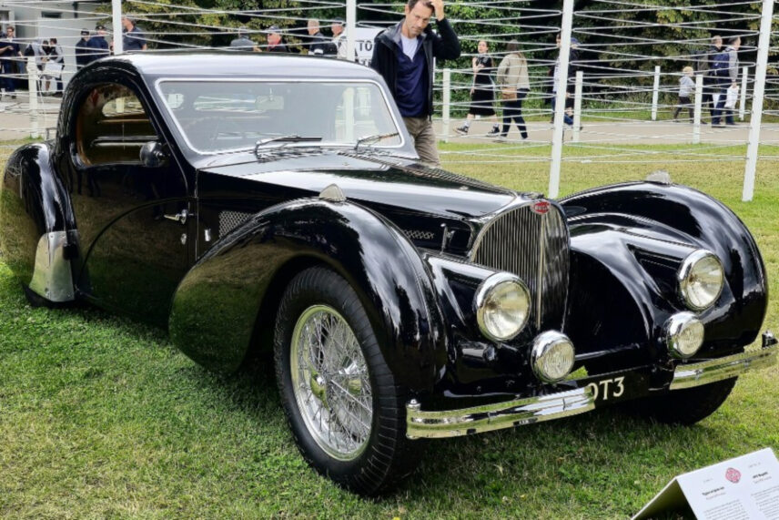 vintage black car parked in field