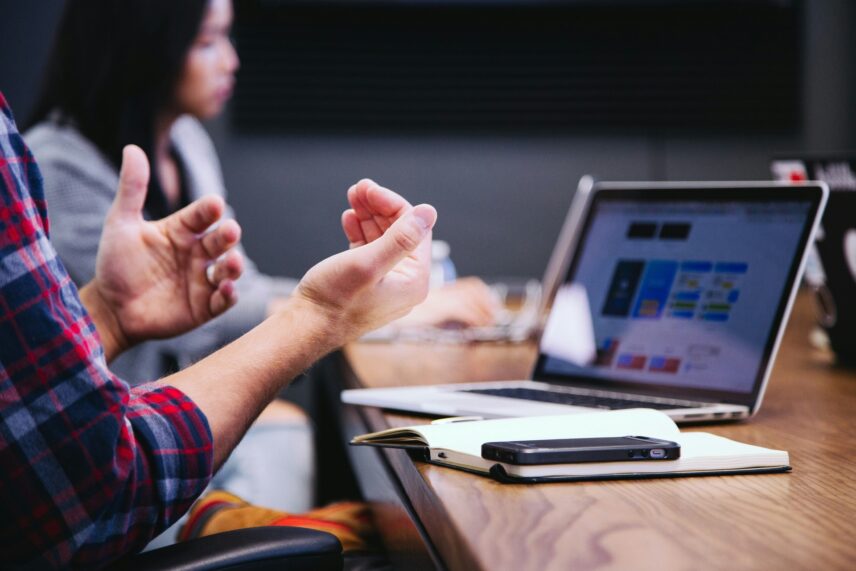 man gesturing to computer