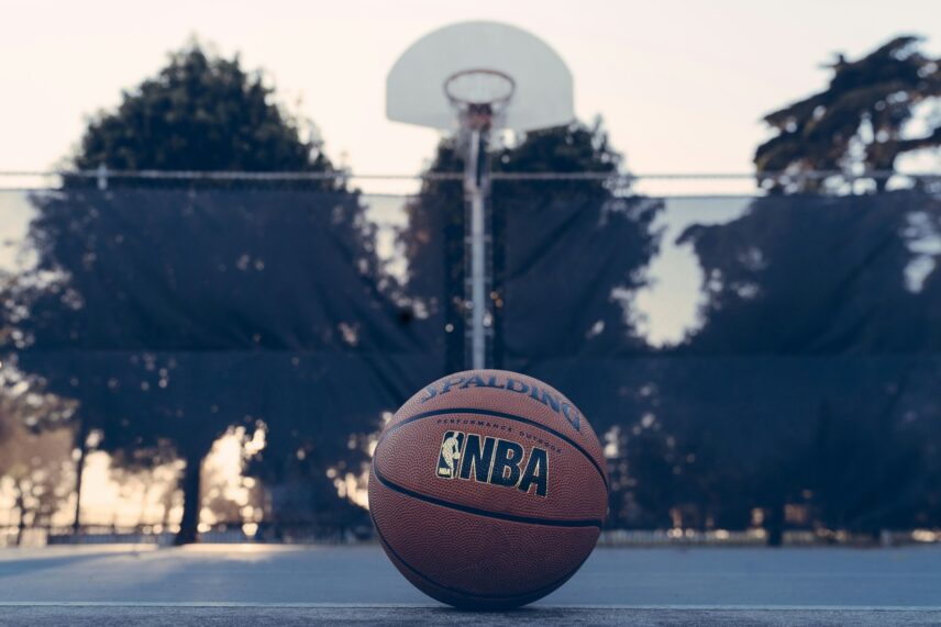 Basketball on the pavement of an outdoor basketball court
