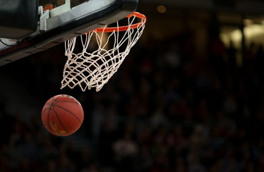 Basketball goes through the net of the hoop