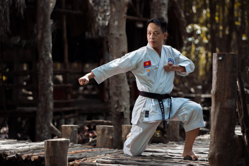 young karate fighter in white suit with black belt
