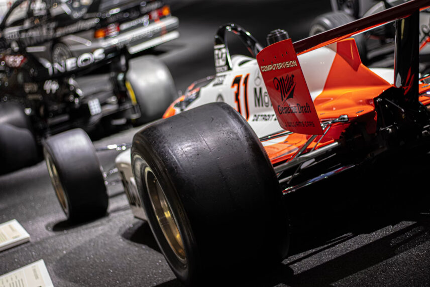 orange and white motor racing car on track
