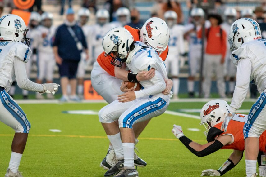 NFL players in a tackle.