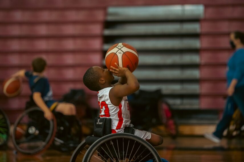 Kid playing wheelchair basketball