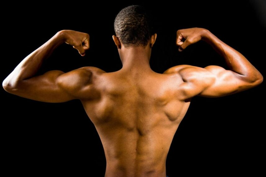 Back side of a man flexing his muscles