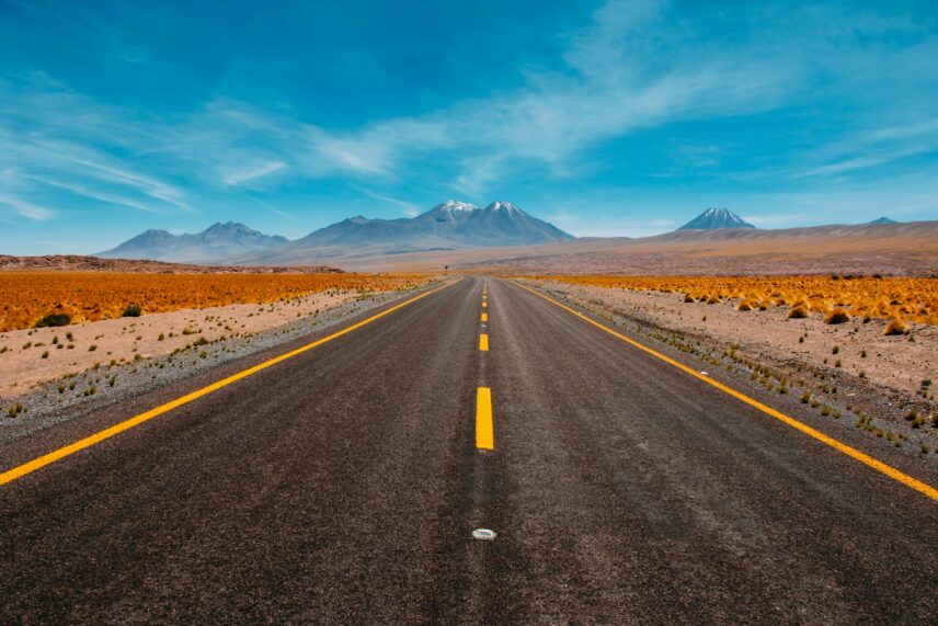 An open road with a blue sky in a desert landscape