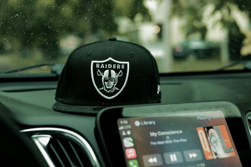 Las Vegas Raiders hat sitting on the dashboard of a car