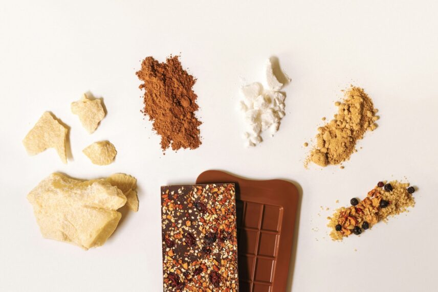 Protein bar with ingredients surrounding it