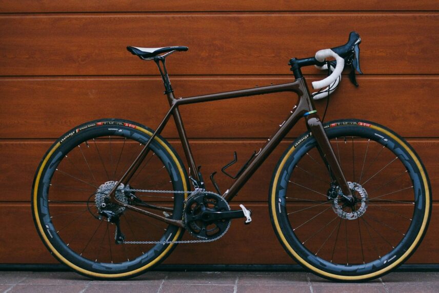 a gravel bike lean on a wooden wall
