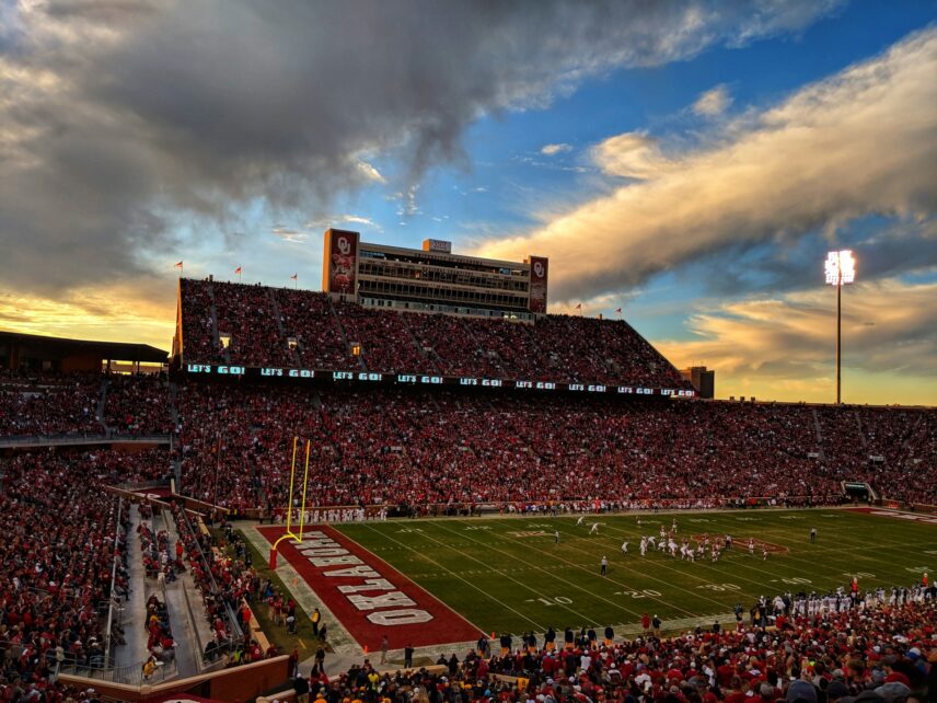 Oklahoma University's football stadium end zone during game at sunset