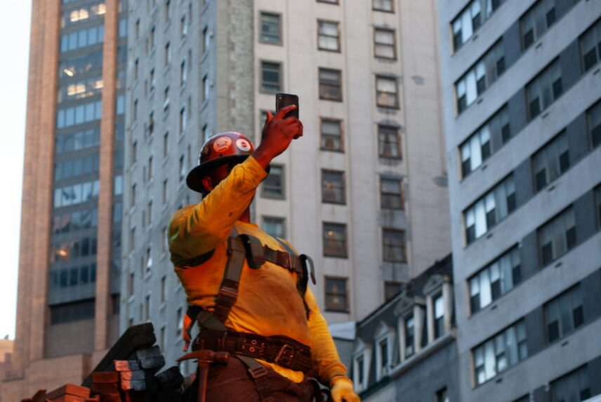 A firefighter holding up a cellphone