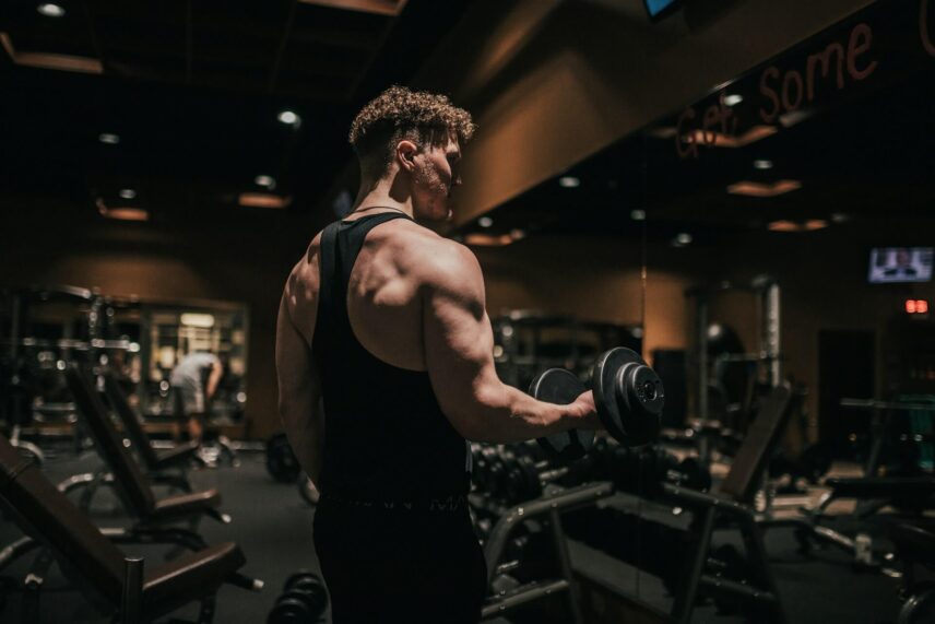 Man holding a dumbbell in a gym