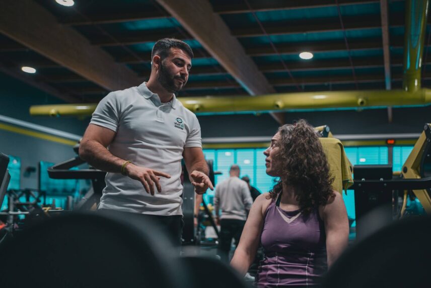 Man talking to a woman at the gym