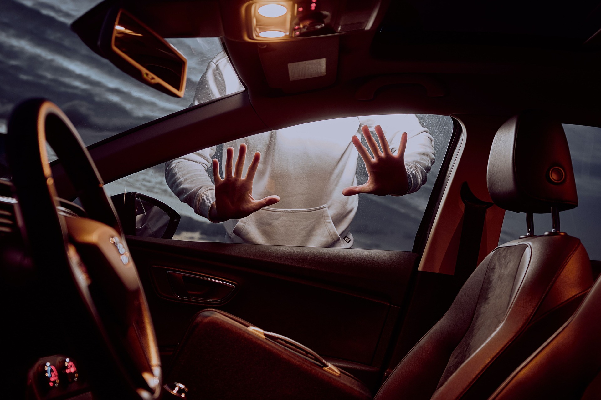 Interior view of a man trying to break into a locked car