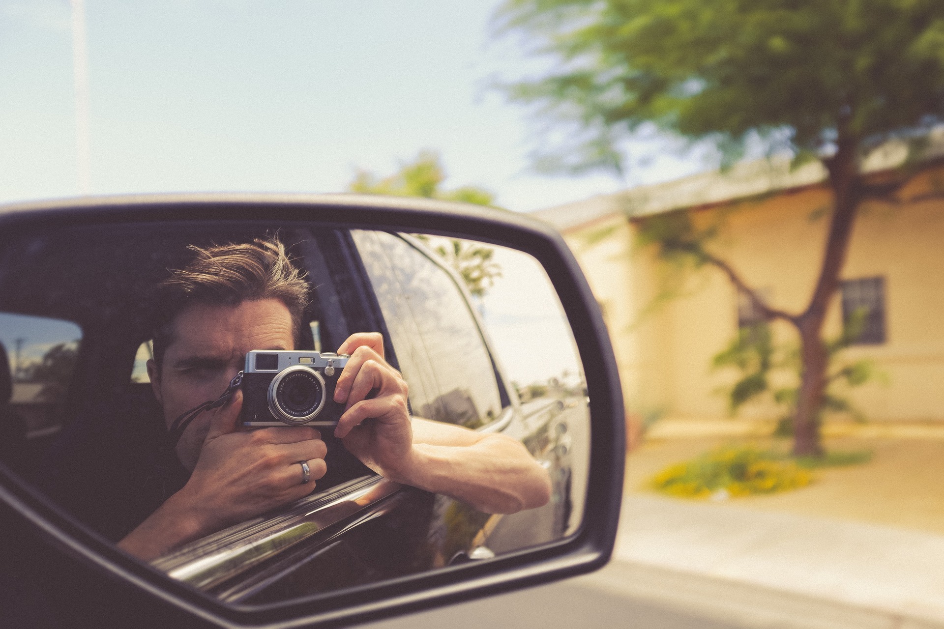 A man taking a selfie from his car