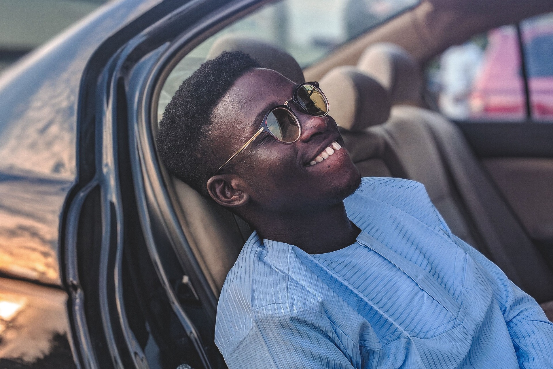 Millennial man smiling in vehicle