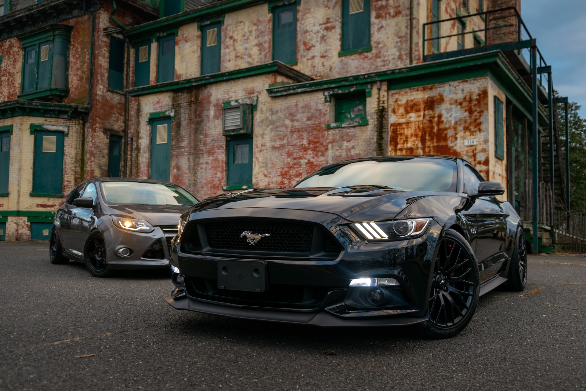 A ground level view of two Ford Mustangs