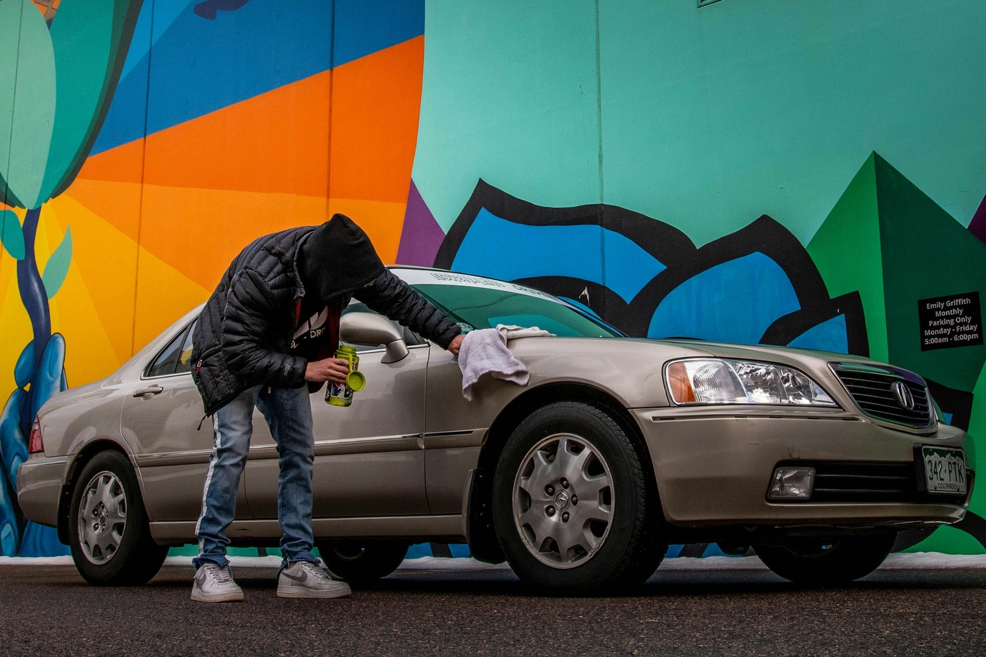 A first-time car owner polishing his car