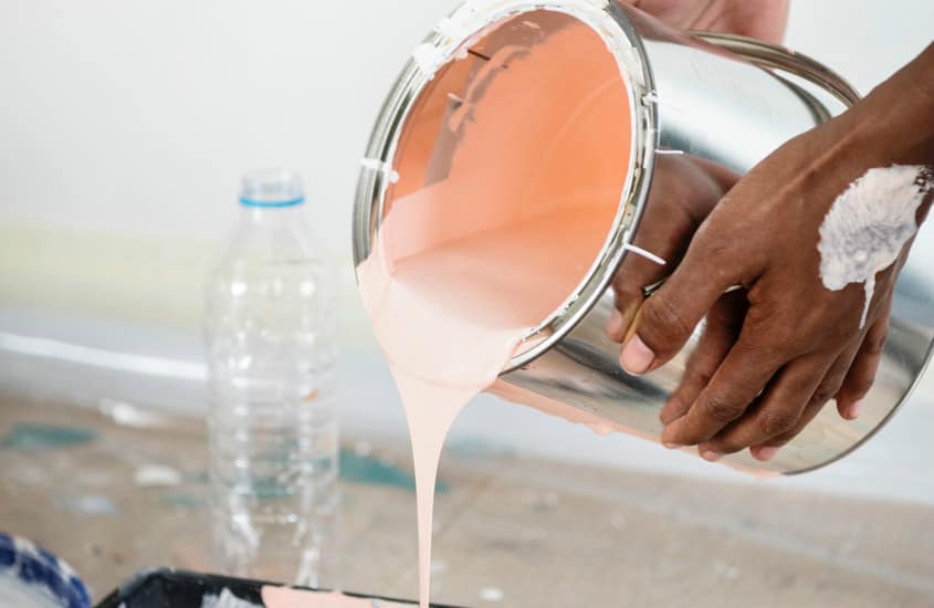 Pouring from a paint can.
