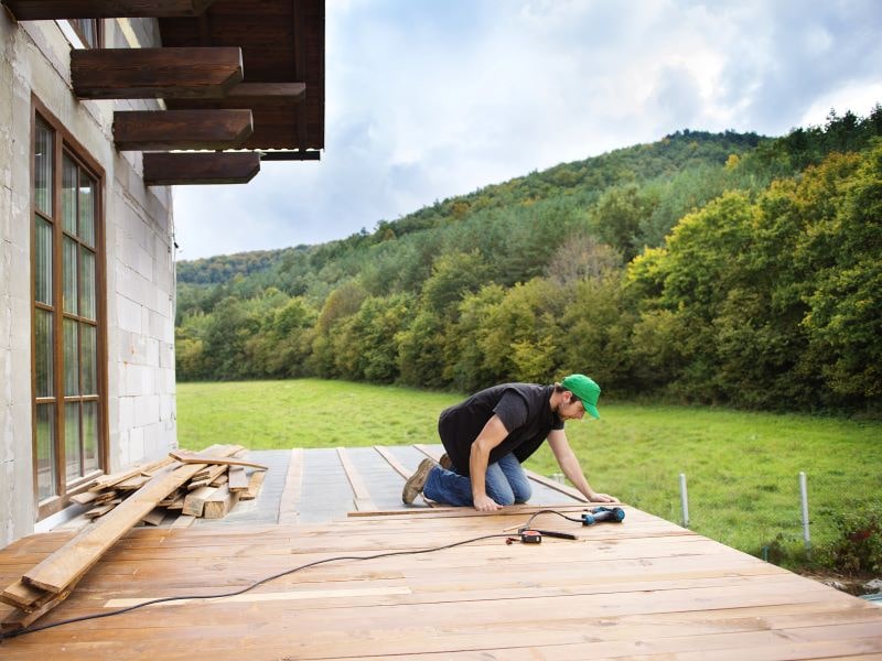 Man working on a deck. 