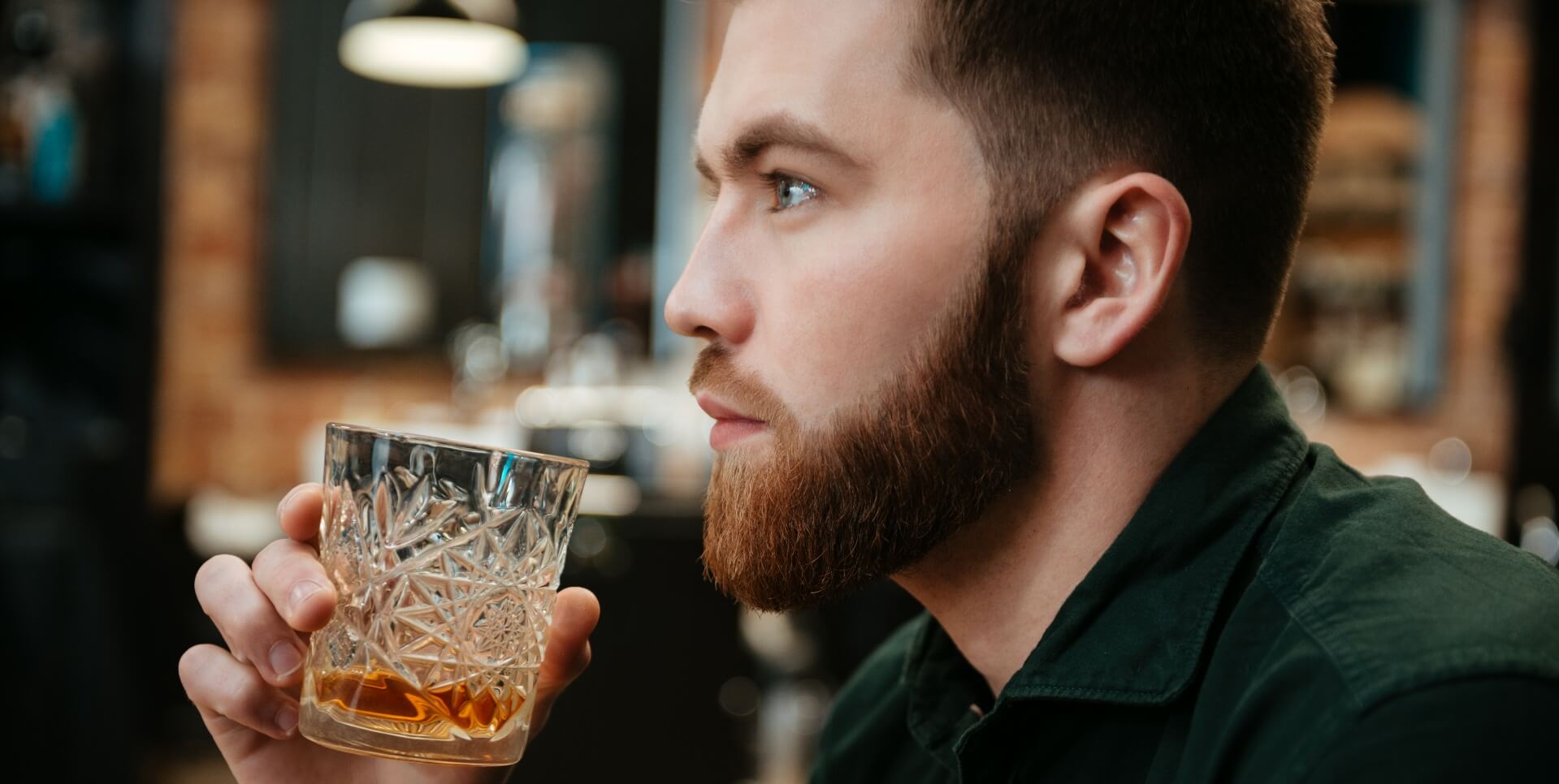 Man drinking a bourbon cocktail.