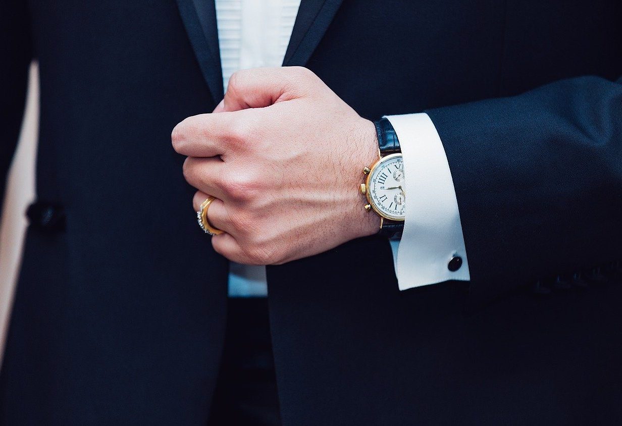 Man in suit with watch.