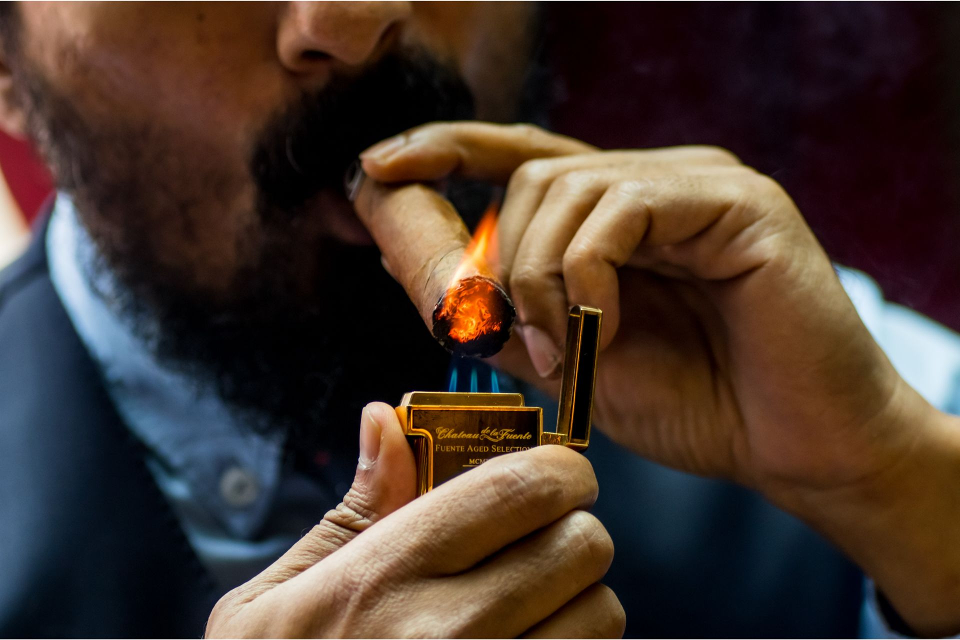 Man lighting cigar.