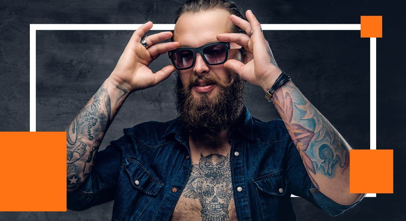 Man with tattoos adjusting sunglassess.