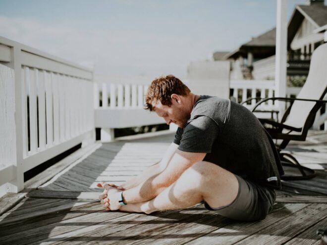man doing yoga on porch