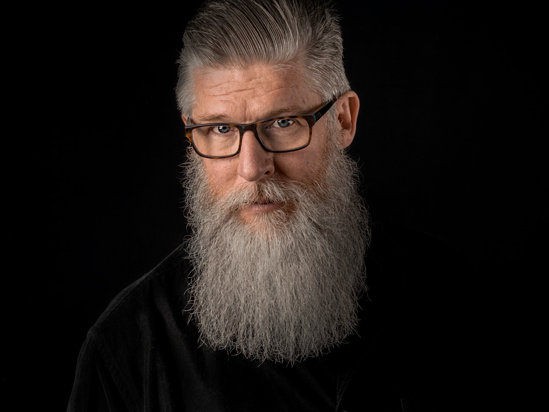 Older man with gray beard.