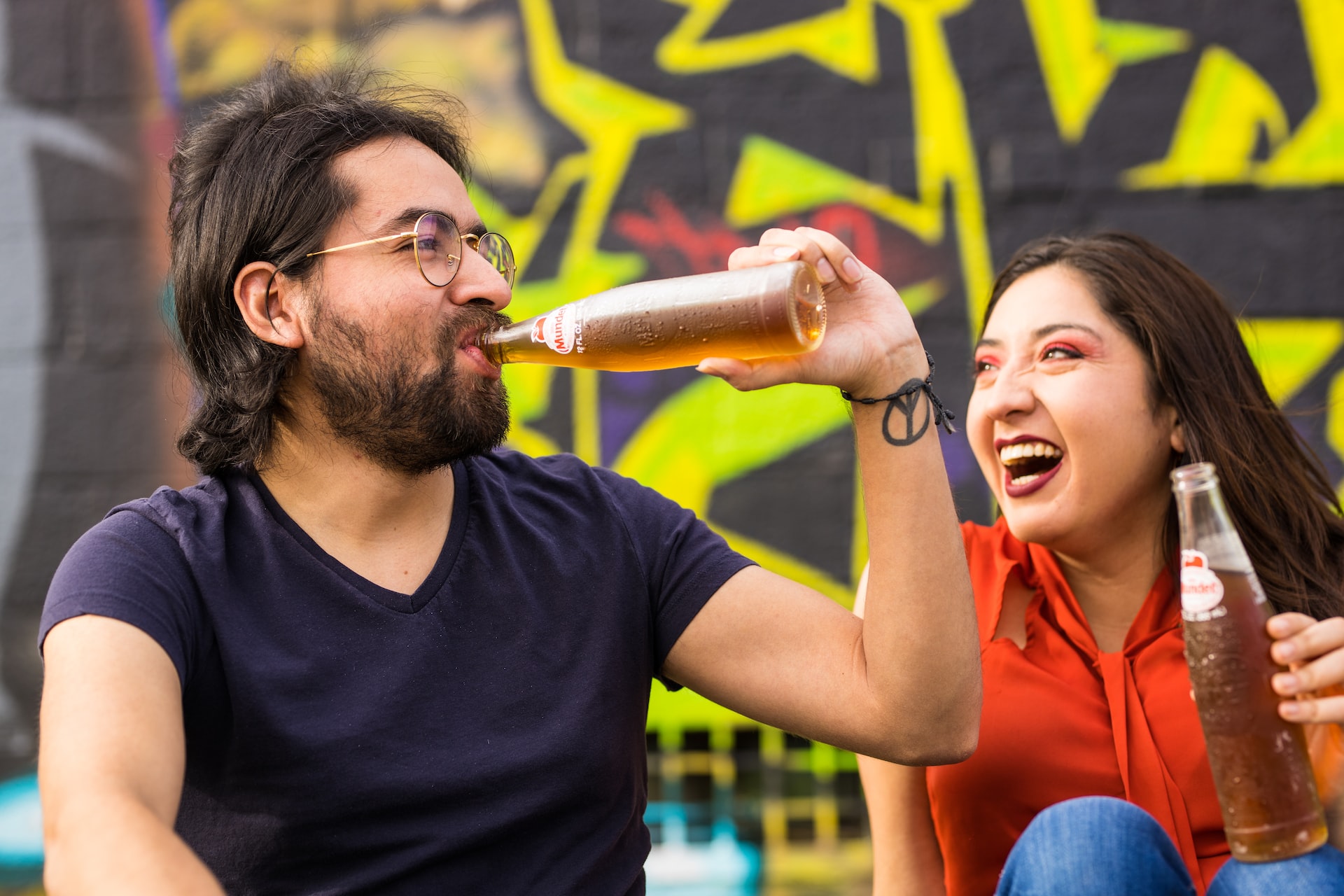 Man and woman drinking a beer.