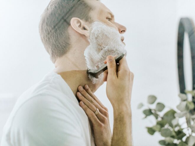 man shaving in front of a mirror