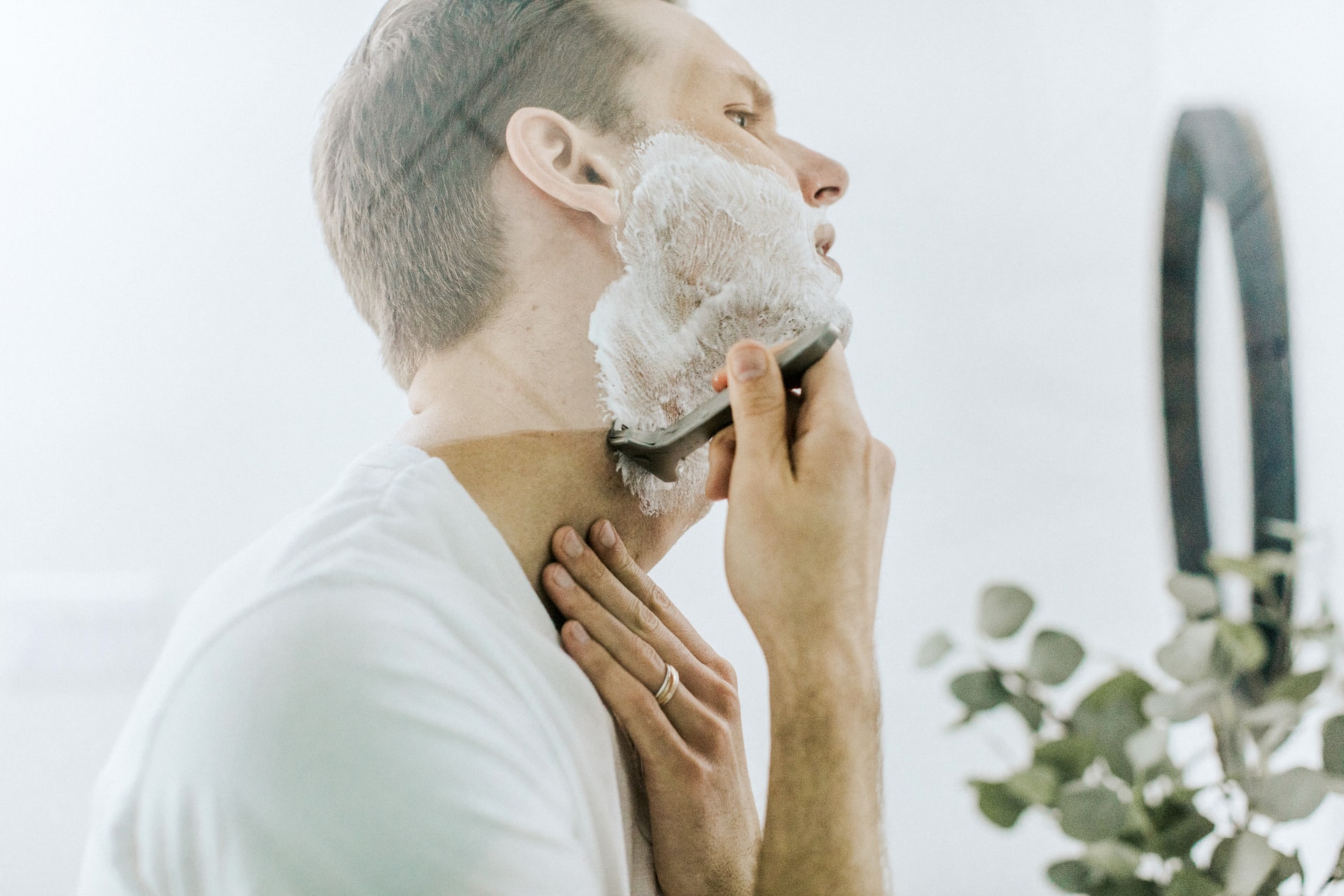man shaving in front of a mirror
