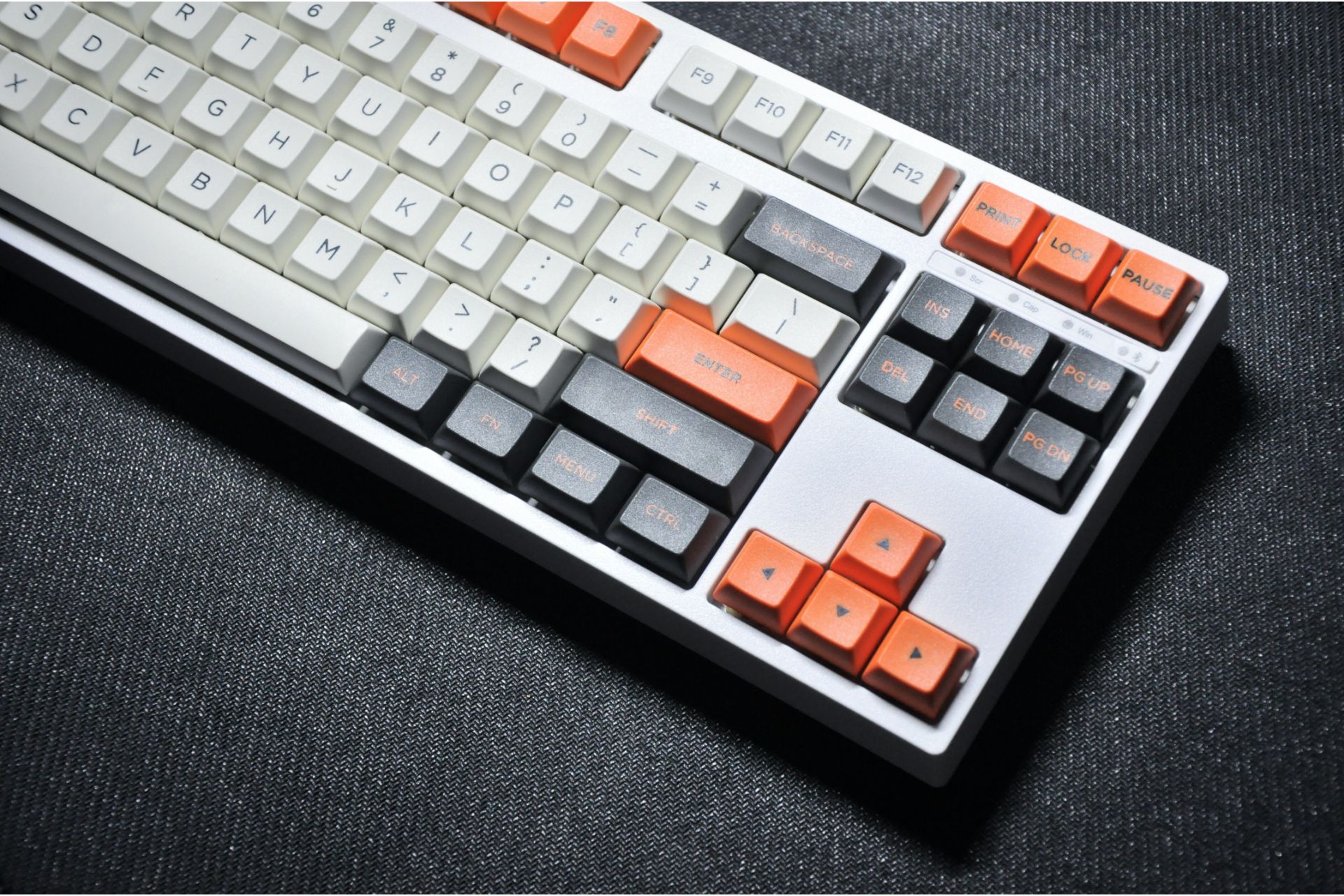 Keyboard with white, orange and black keys.