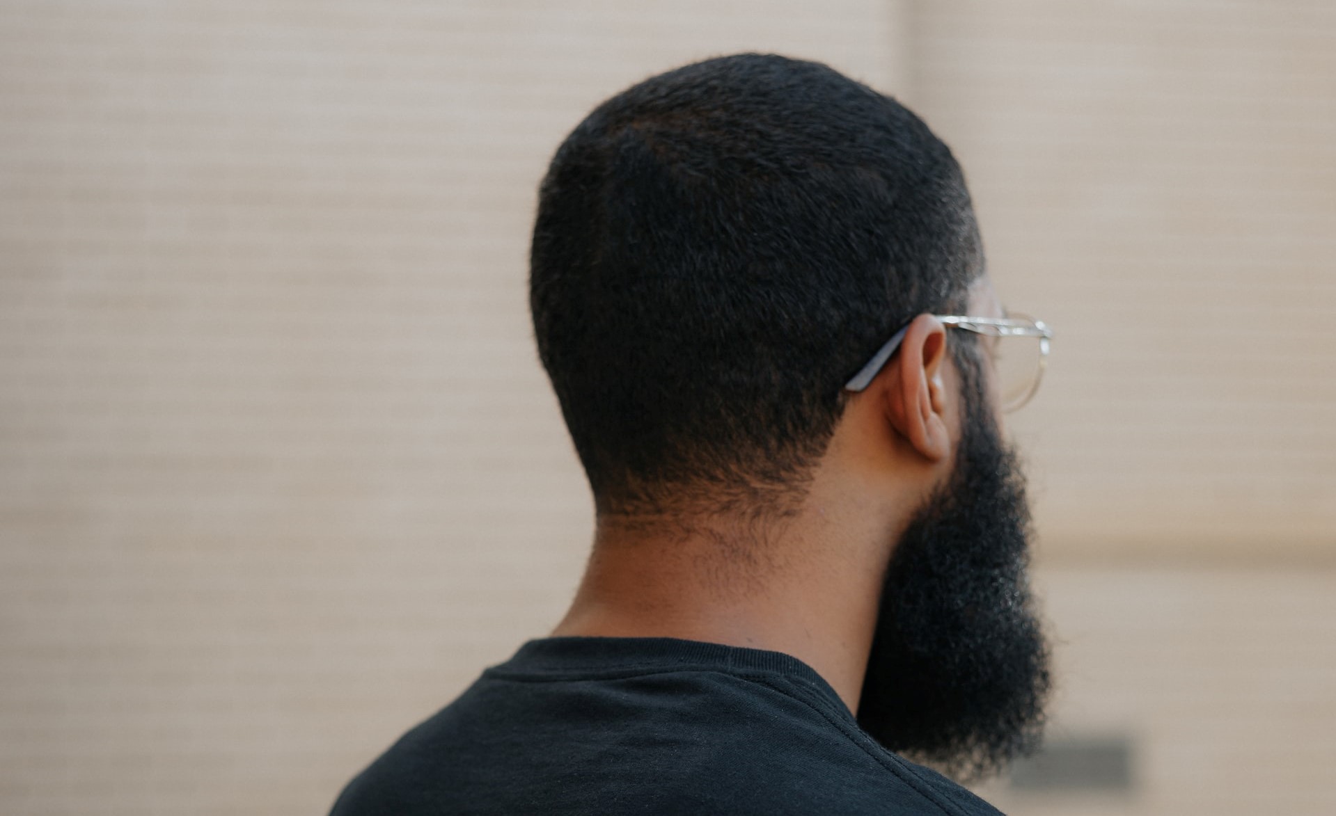 Back of the head of a man with a beard.