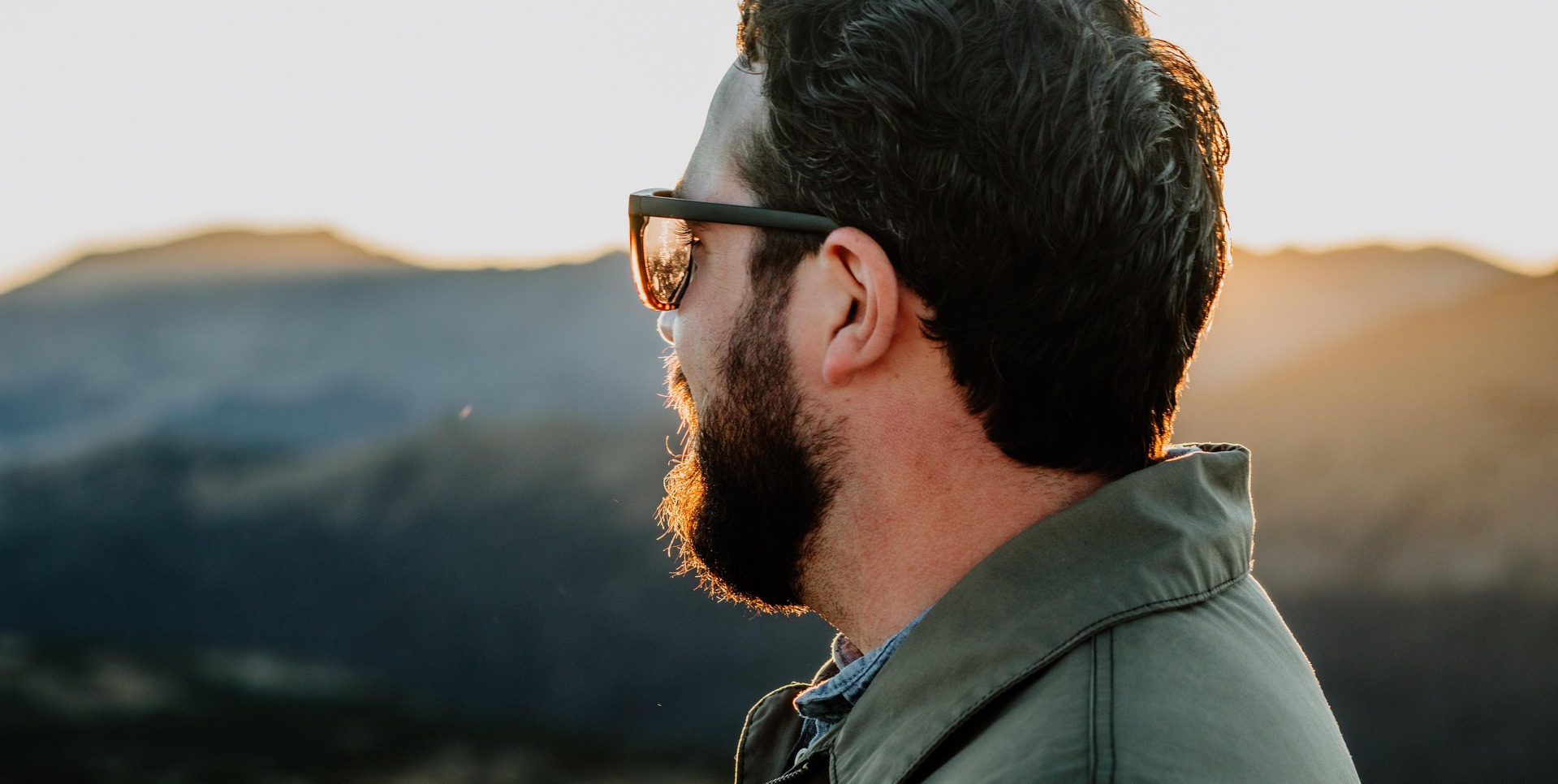 Profile view of man with beard and sunglasses.