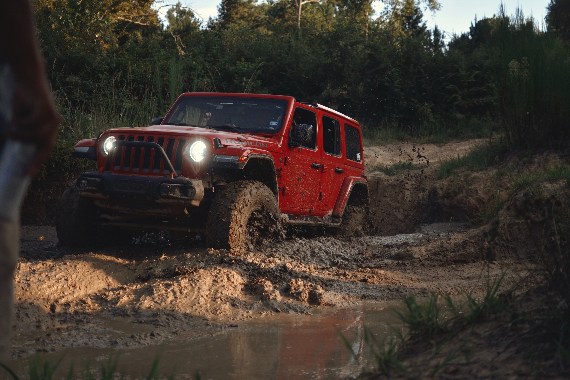 Jeep driving through mud.