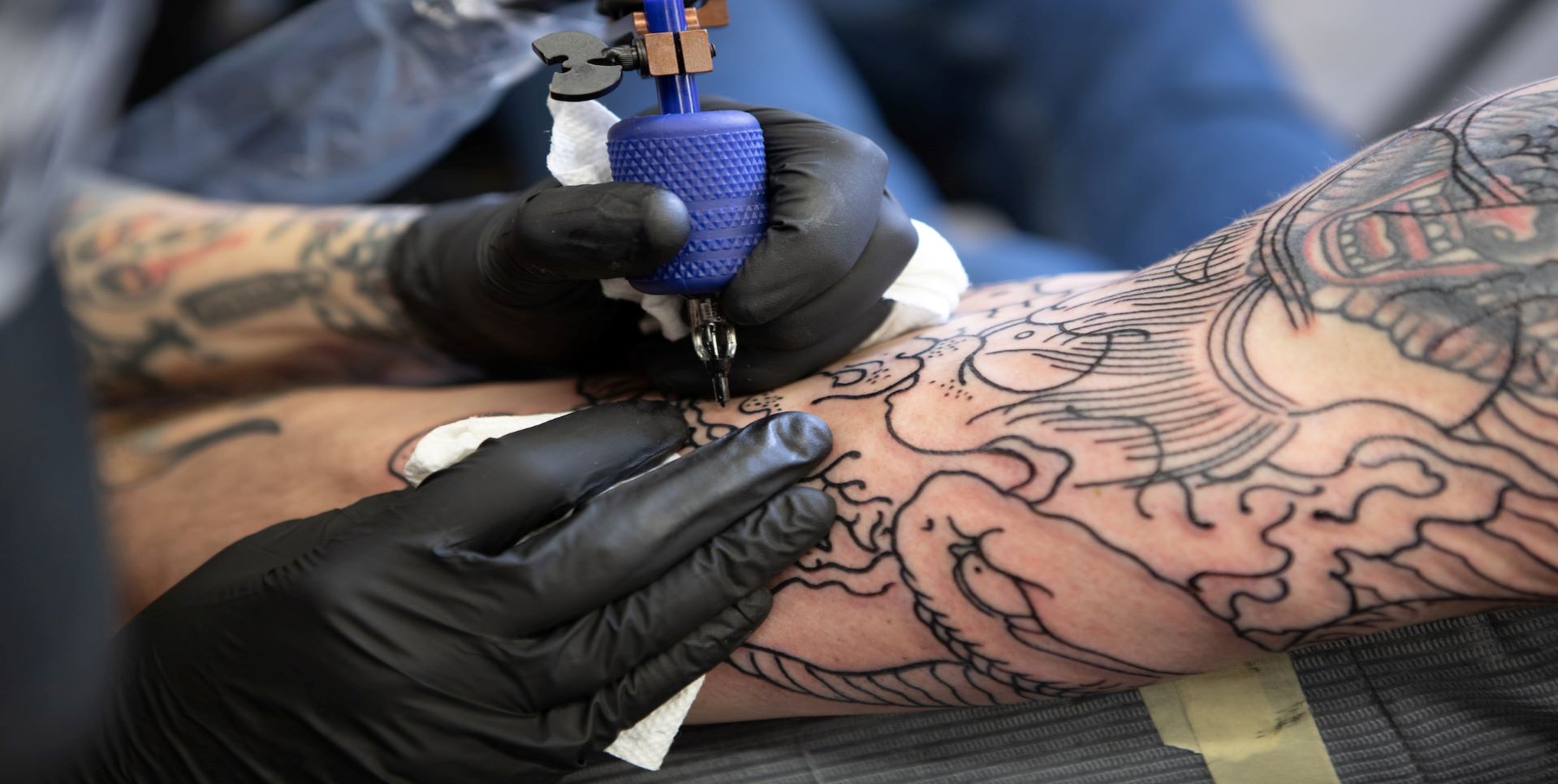 Man getting a tattoo on his arm.