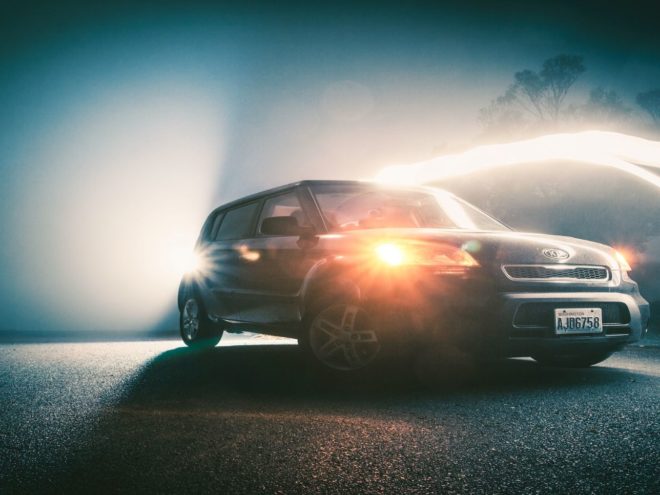 Car in the dark with lights on.