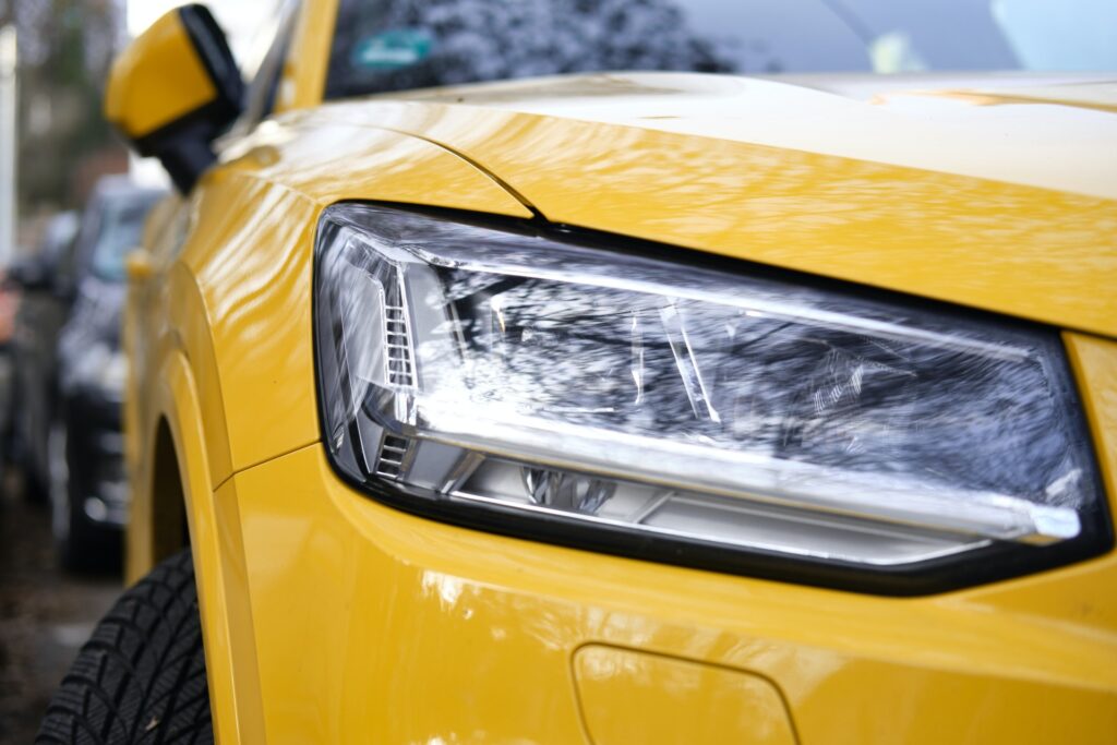 headlight closeup on a yellow car