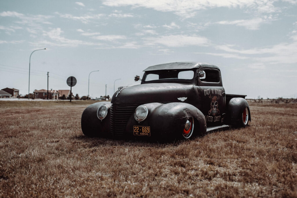 A custom rat rod from Kansas resting in the grass.
